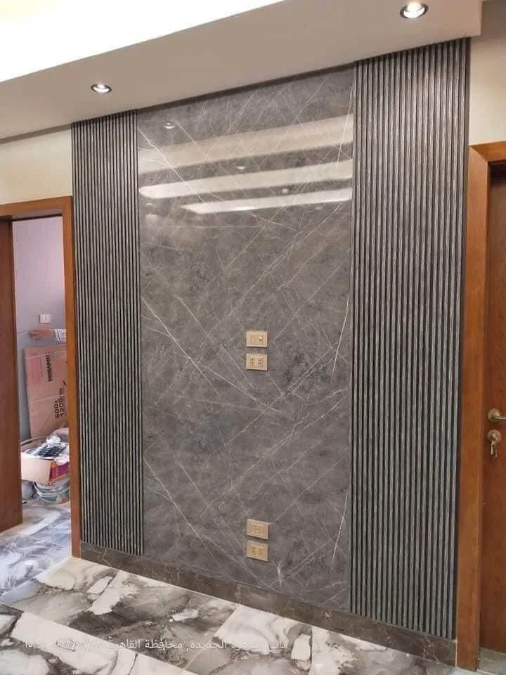 Durable UV marble sheet installed in living room feature wall.