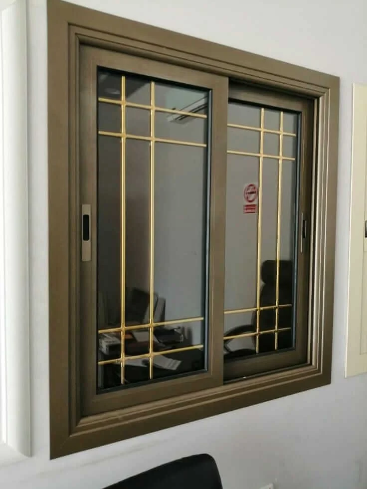 Modern aluminium sliding window with decorative golden grill