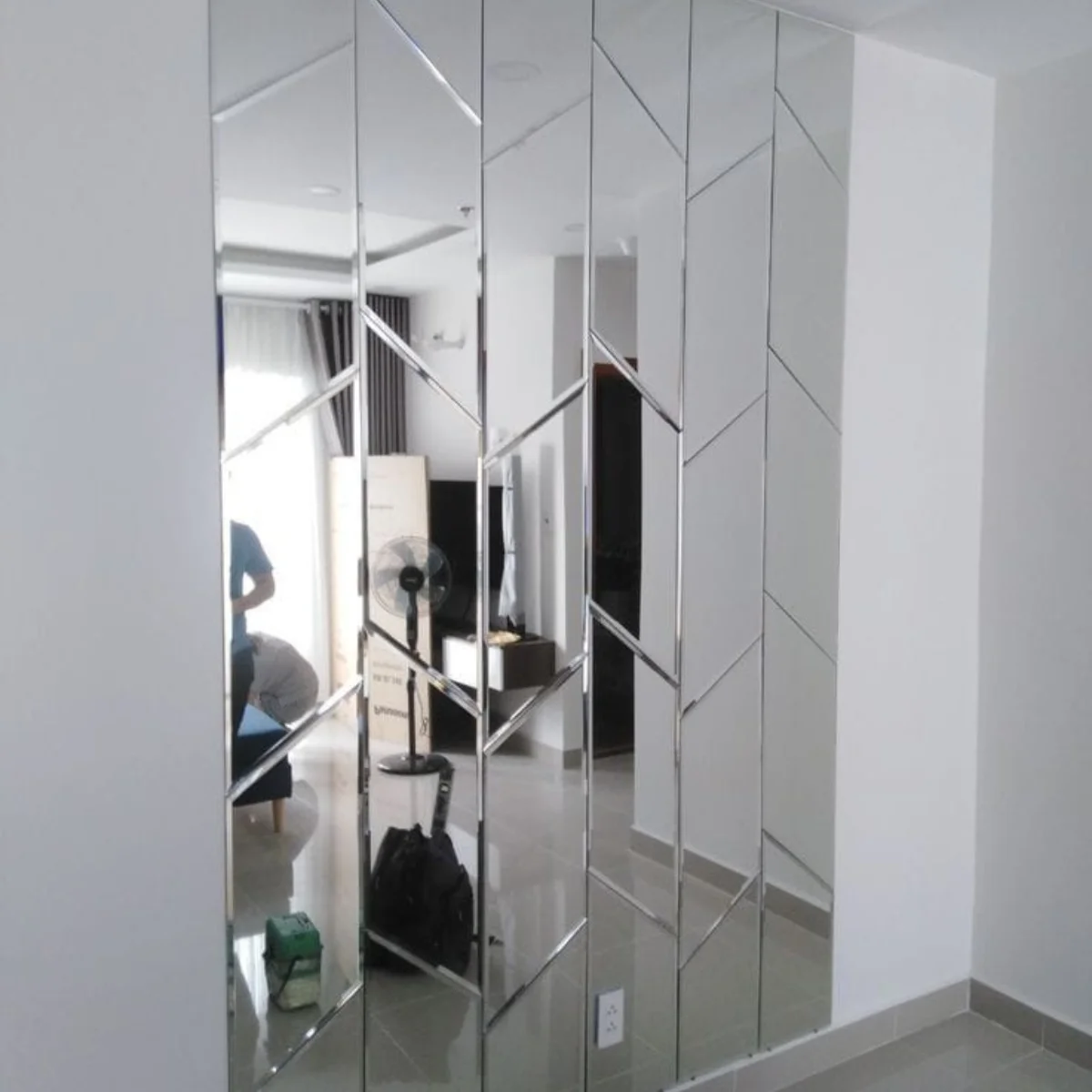 Geometric beveled mirror panels for feature wall